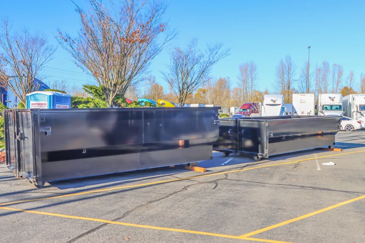 Professional dumpster rental service with roll-off container on residential driveway in Tallahassee